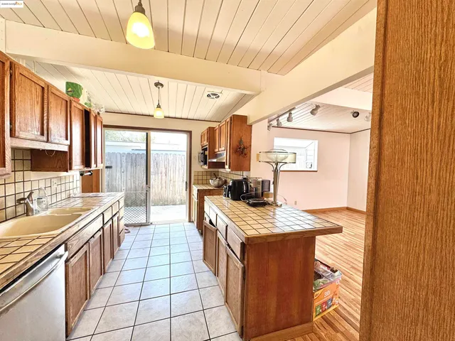 a open kitchen with stainless steel appliances granite countertop a sink stove and refrigerator