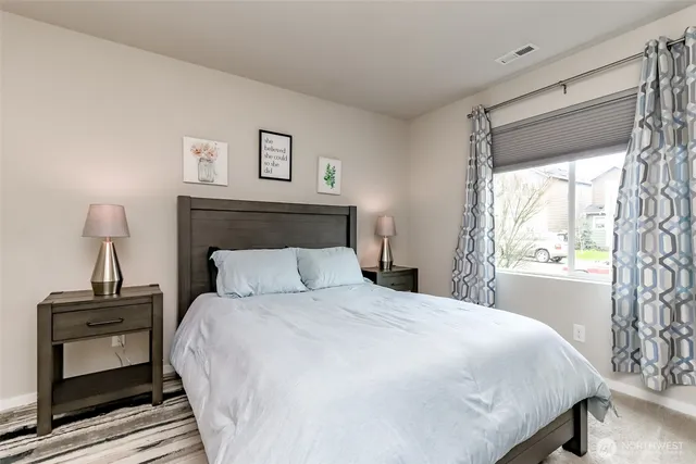 a bedroom with a bed and a window