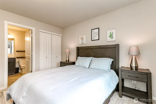 a bedroom with a bed and a lamp