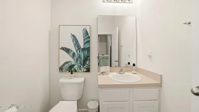 a bathroom with a toilet a sink and a mirror