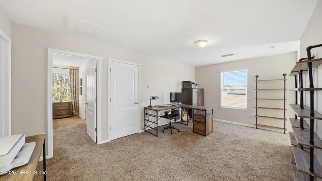 a view of a livingroom with furniture and a window