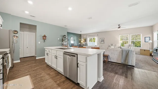 a kitchen with sink stove and refrigerator