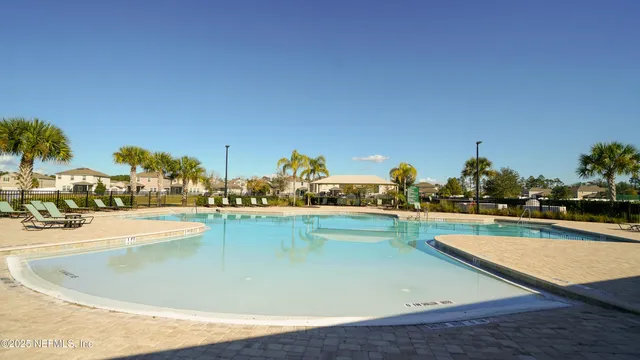 a view of a swimming pool with an outdoor seating