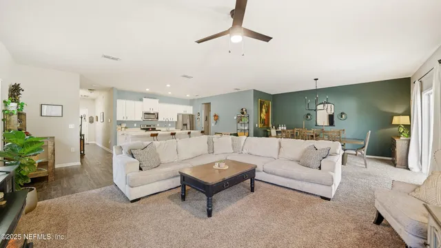 a living room with furniture white walls and white walls