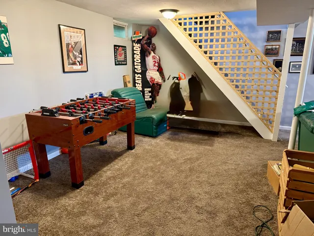 a living room with table chairs and a potted plant
