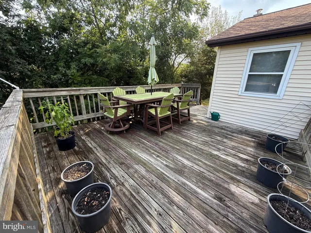 a view of a chairs and table on the roof deck