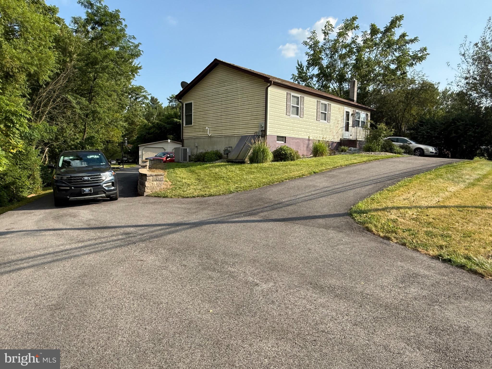 2856 West Canal Road Dover, PA 17315 - Photo 2 of 20 a view of a house with a yard and garage