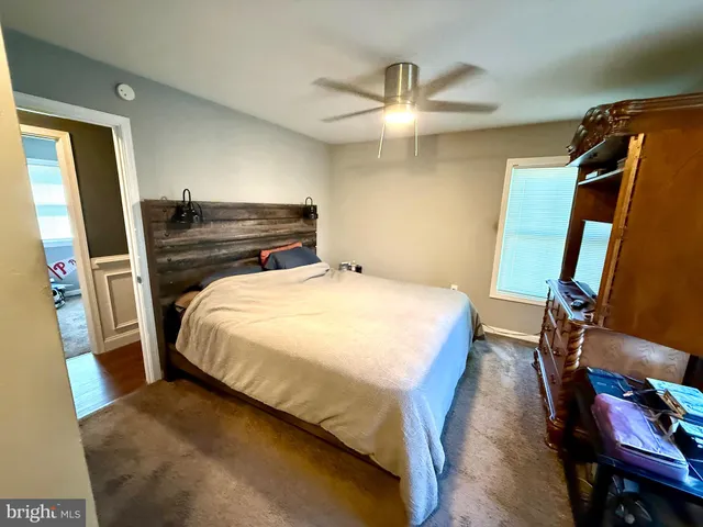 a bed sitting in a room next to a window