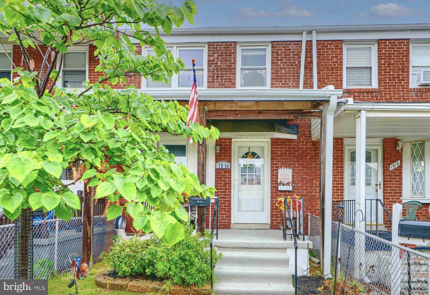 a front view of a house with plants
