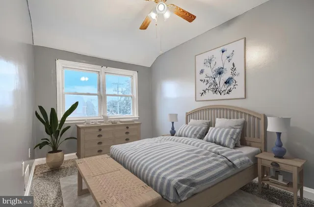 a bedroom with a large bed and a window