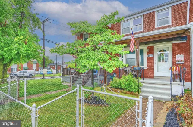 a front view of a house with a yard table and chairs