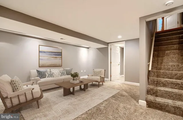 a living room with furniture and stairs