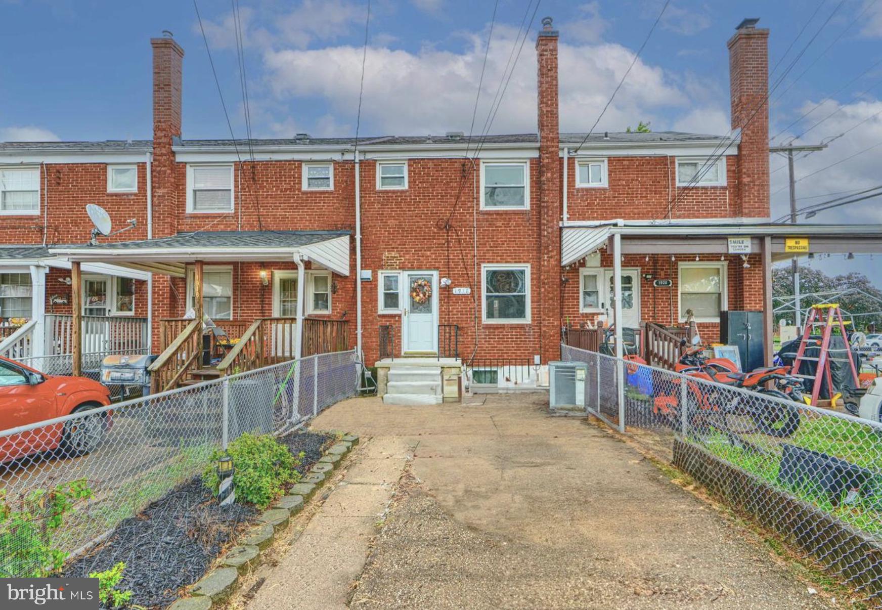 1918 Larkhall Road Baltimore, MD 21222 - Photo 3 of 25 front view of a brick house with a yard