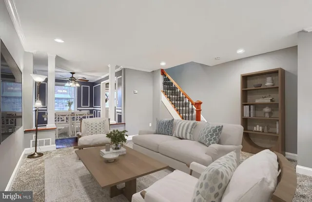 a living room with furniture a rug and a wooden floor