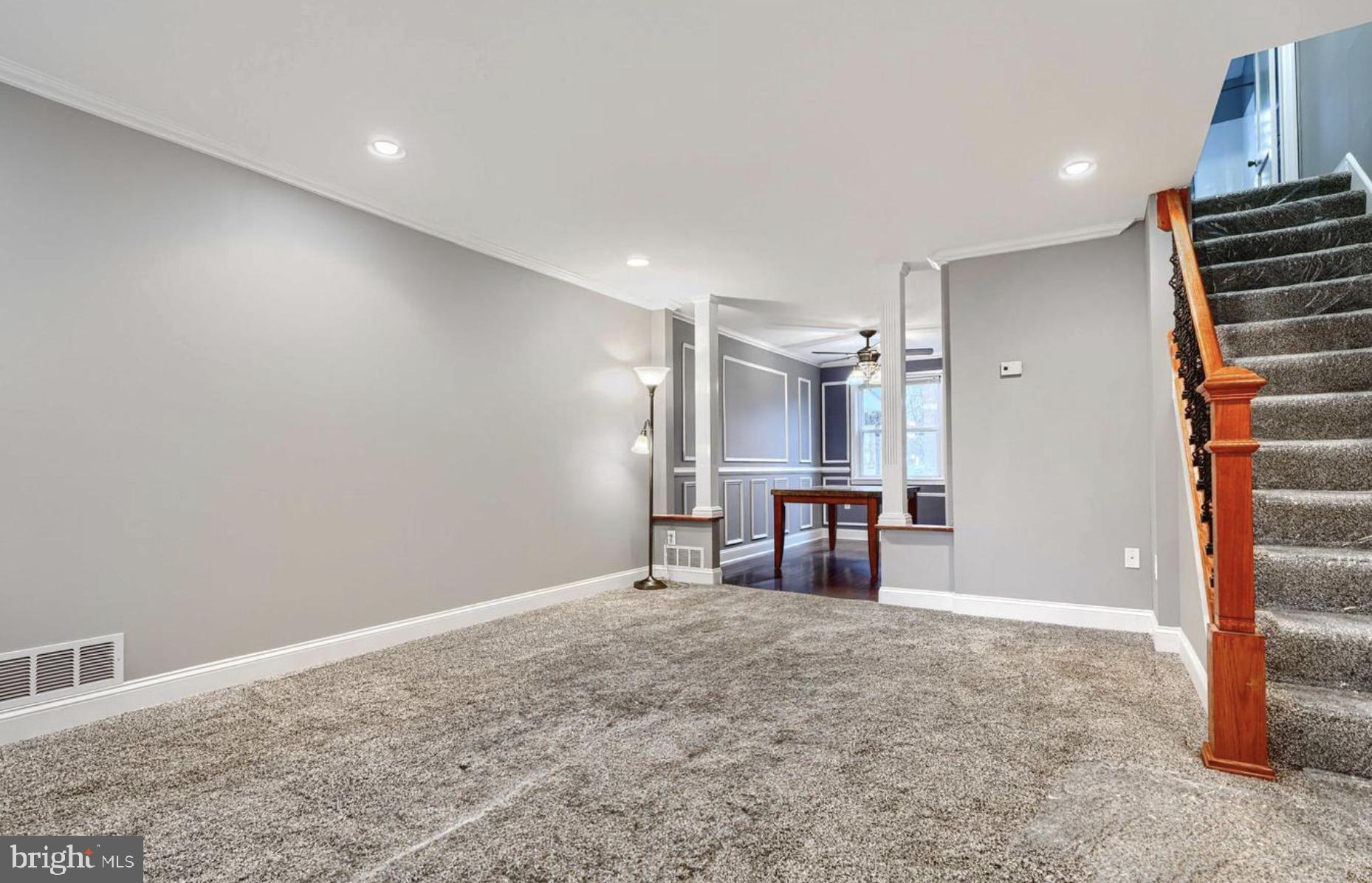 1918 Larkhall Road Baltimore, MD 21222 - Photo 6 of 25 a view of empty room with stairs and wooden floor