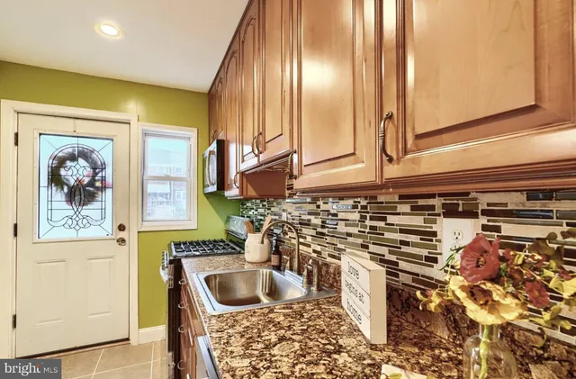 a kitchen with a sink and a refrigerator