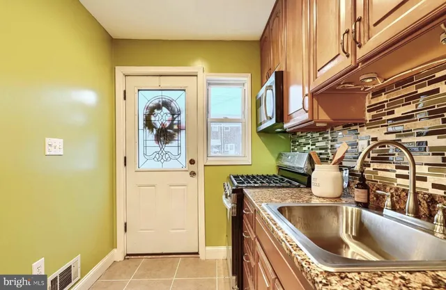 a kitchen with a sink and a refrigerator
