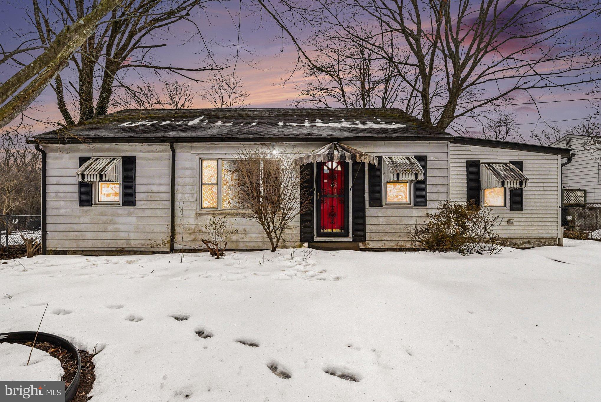 Charming home nestled in a snowy landscape.