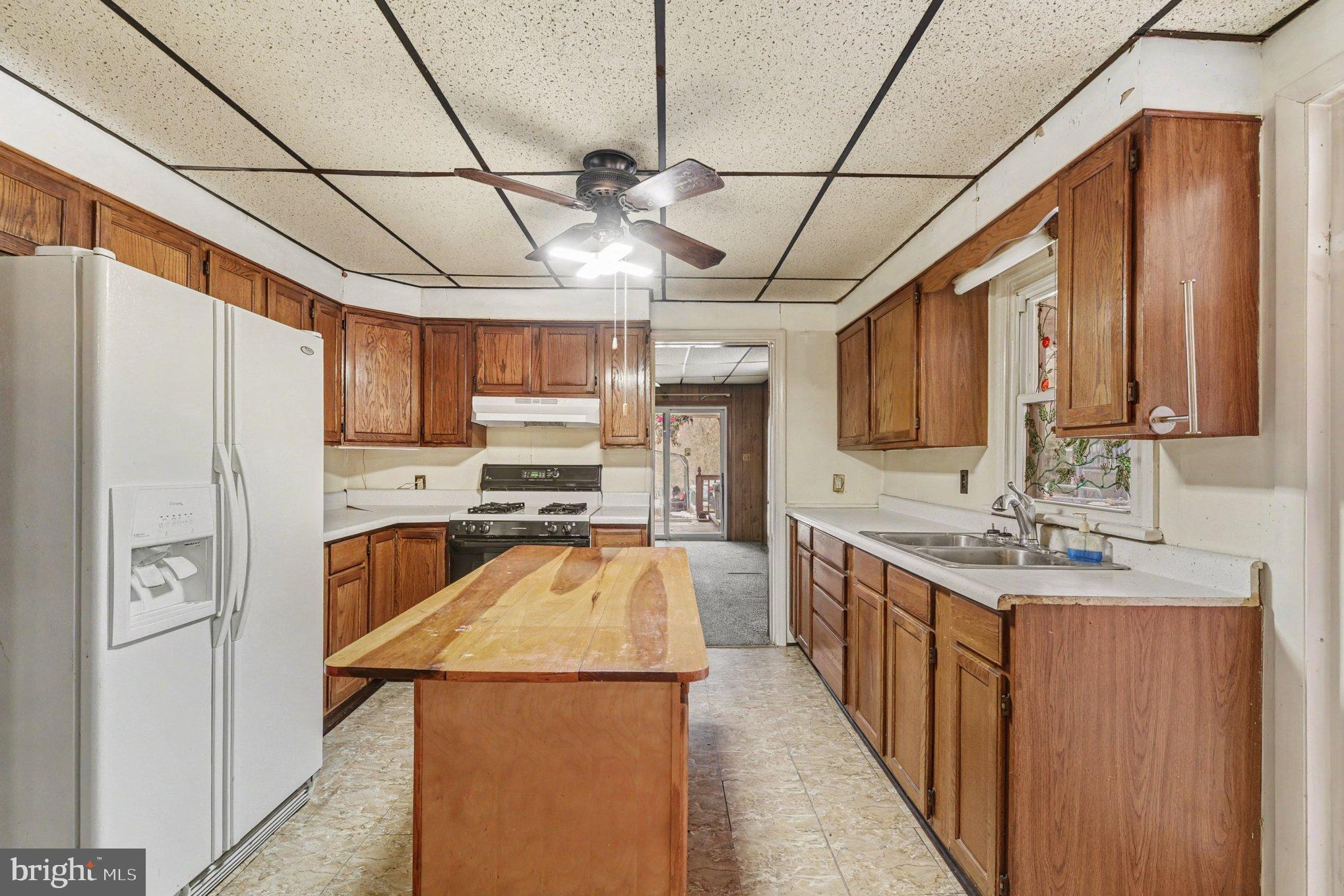 1433 Old Philadelphia Road Aberdeen, MD 21001 - Photo 11 of 32 a kitchen with stainless steel appliances granite countertop a sink a stove and a refrigerator