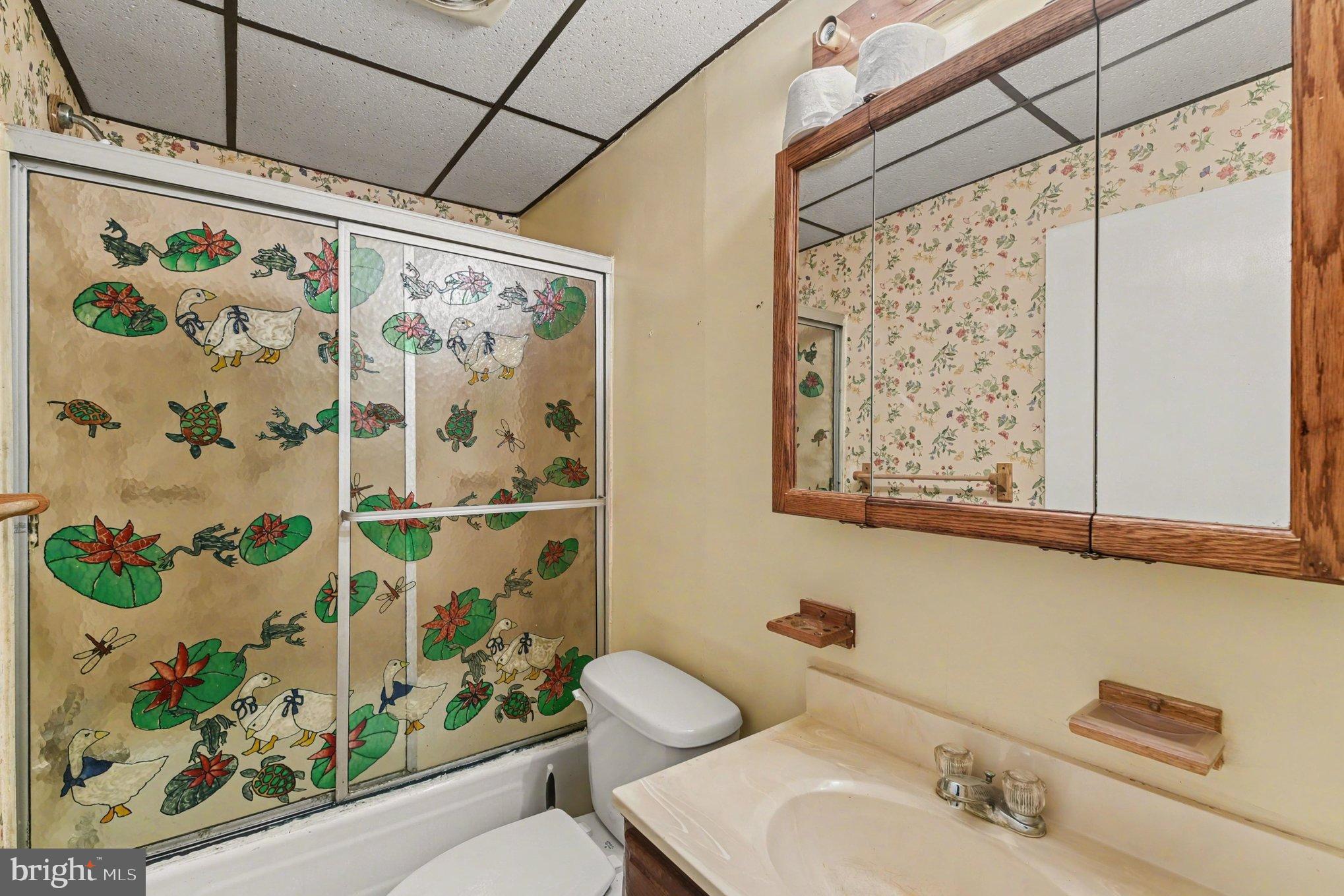 1433 Old Philadelphia Road Aberdeen, MD 21001 - Photo 13 of 32 a bathroom with a shower curtain and a sink