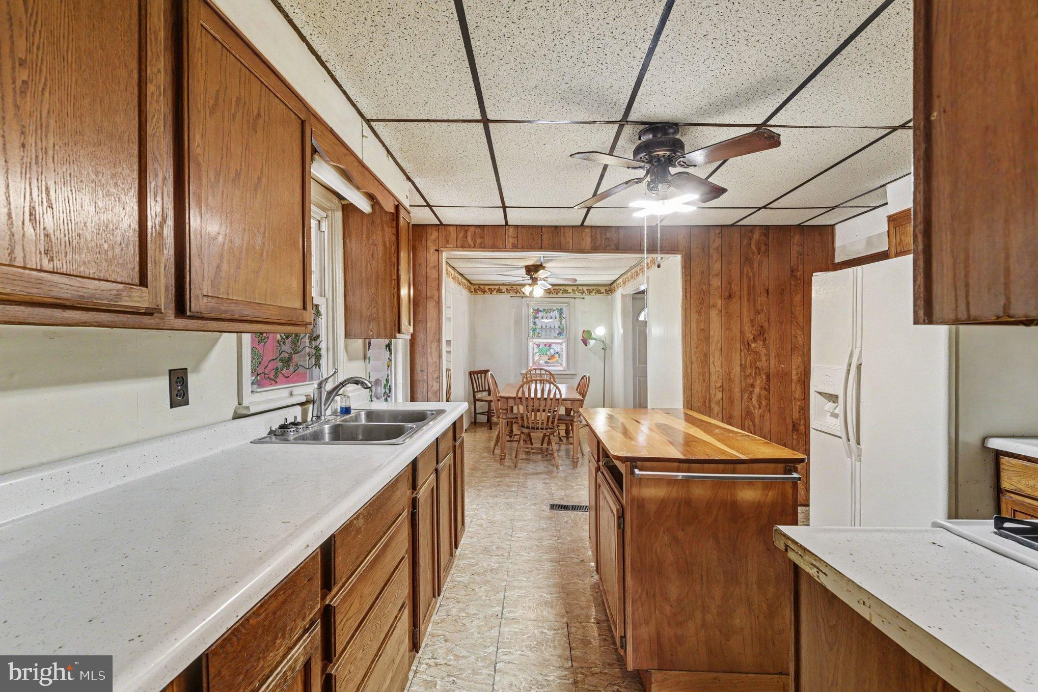 1433 Old Philadelphia Road Aberdeen, MD 21001 - Photo 10 of 32 a kitchen with sink refrigerator and cabinets