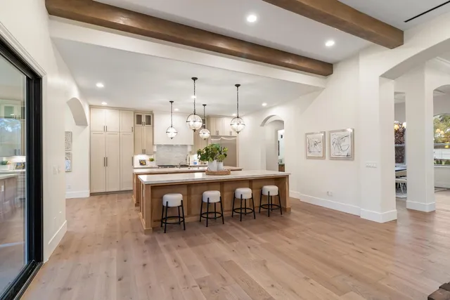 a view of a dining room with furniture and a chandelier