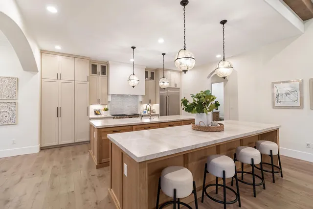 a bed room with a bed mirror and a chandelier