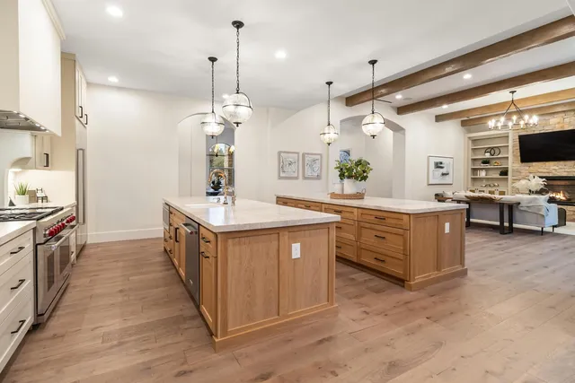 a spacious bathroom with a double vanity sink large mirror bathtub and next to a window