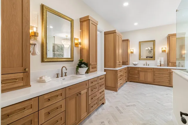 a living room with furniture a large window and a potted plant