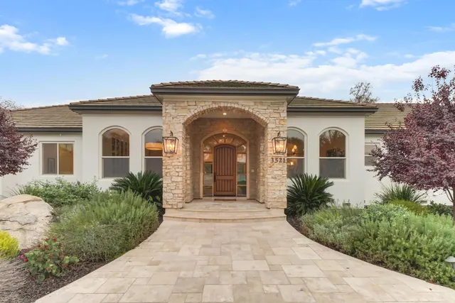 a view of a dining room with furniture wooden floor and chandelier
