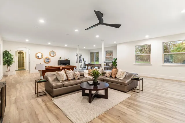 a living room with furniture a rug and a window