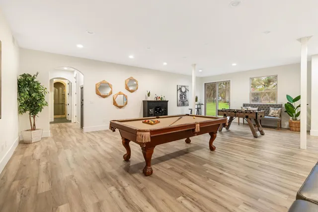 a living room with furniture a clock on wall and a table