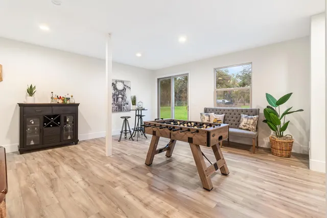 a living room with furniture a flat screen tv and a window