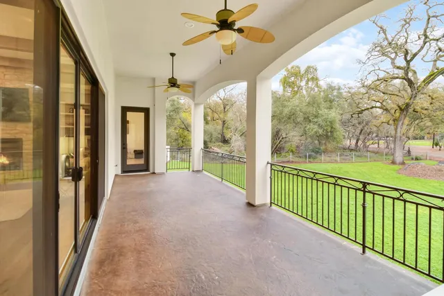 an aerial view of a house with a garden and lake view