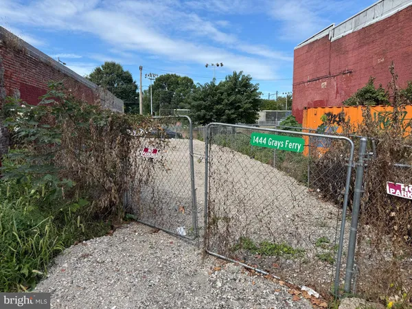 a view of a pathway with a wrought fence