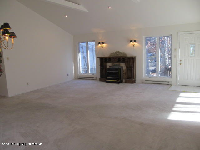 330 Canterbury Road Bushkill, PA 18324 - Photo 7 of 22 a view of an empty room with a fireplace and a window