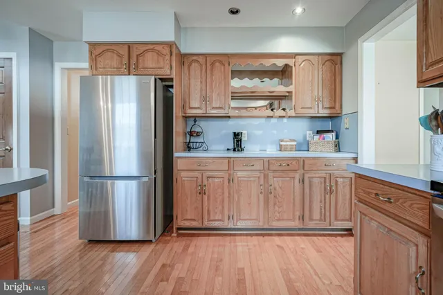 a kitchen with stainless steel appliances a refrigerator sink and cabinets