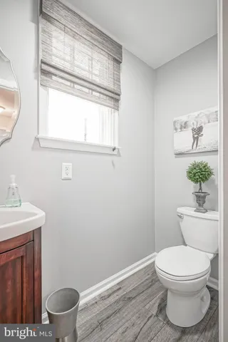 a white toilet sitting next to a bathroom sink