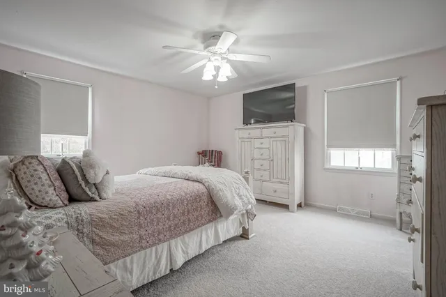 a bedroom with a large bed and a flat screen tv