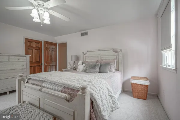 a bedroom with a bed a table and chair