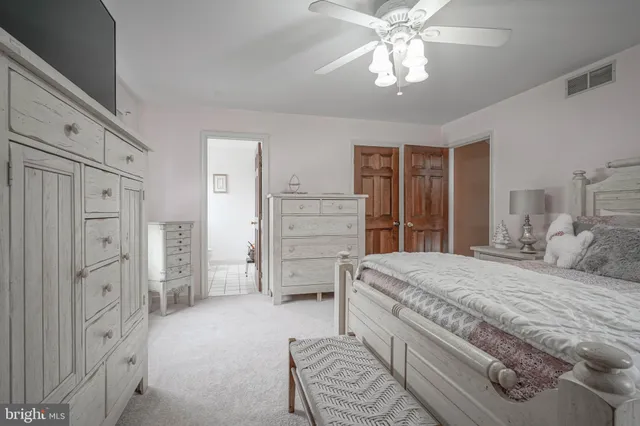 a spacious bedroom with a bed and a chandelier