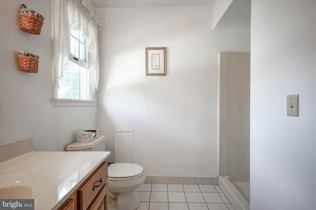 a white toilet sitting next to a bathroom sink