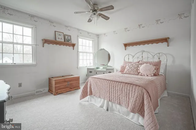 a bedroom with a bed a table and chair