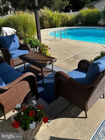 a view of a patio with a table and chairs under an umbrella