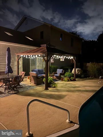 an aerial view of a house with swimming pool and a garden