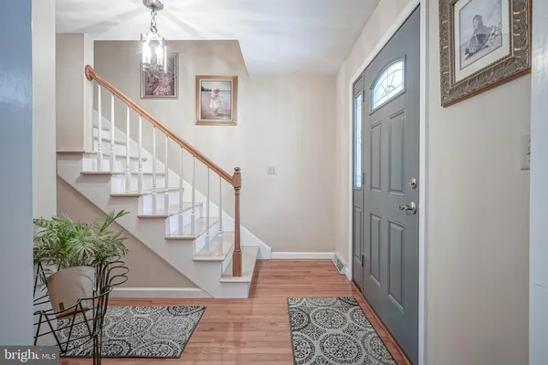 a view of entryway and hall with wooden floor