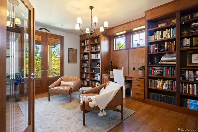 a living room with furniture and a book shelf