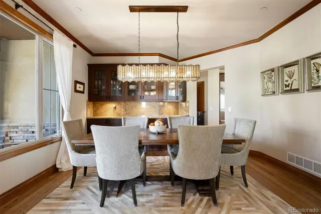 a living room with stainless steel appliances kitchen island granite countertop furniture and a wooden floor