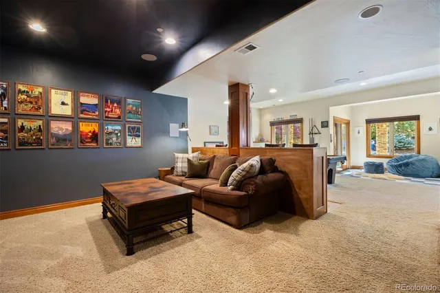 a living room with furniture a projector and a flat screen tv