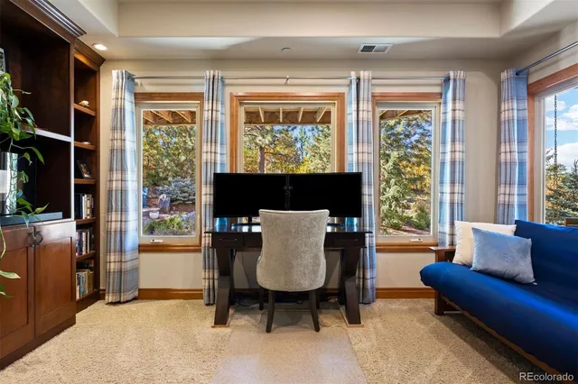 a living room with furniture a large window and a flat screen tv